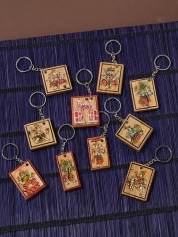 Handicraft ganjifa keychain featuring miniature circular artwork inspired by traditional playing cards